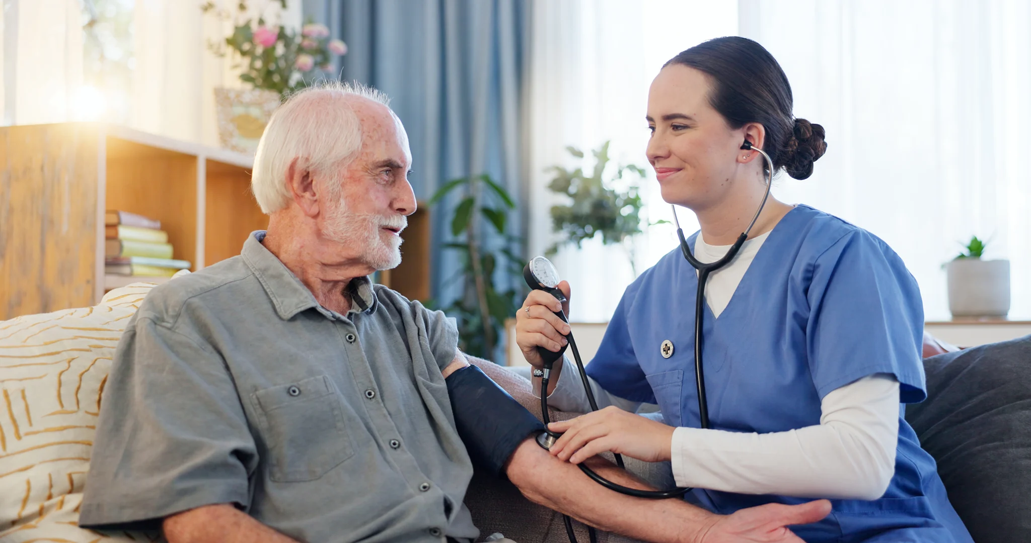 Skilled home health nurse providing in-home blood pressure monitoring and senior medical care services.