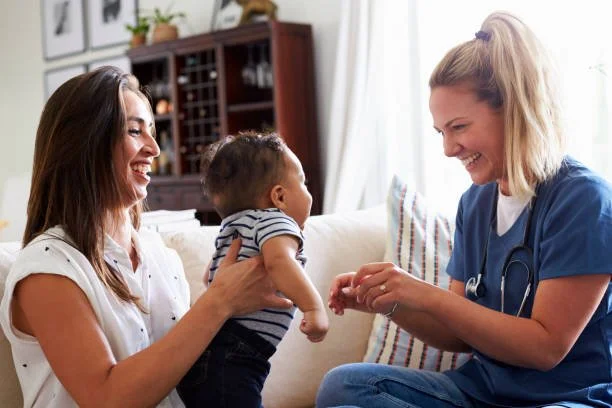 Pediatric private duty nurse meeting with a mother and child during an in-home nursing visit
