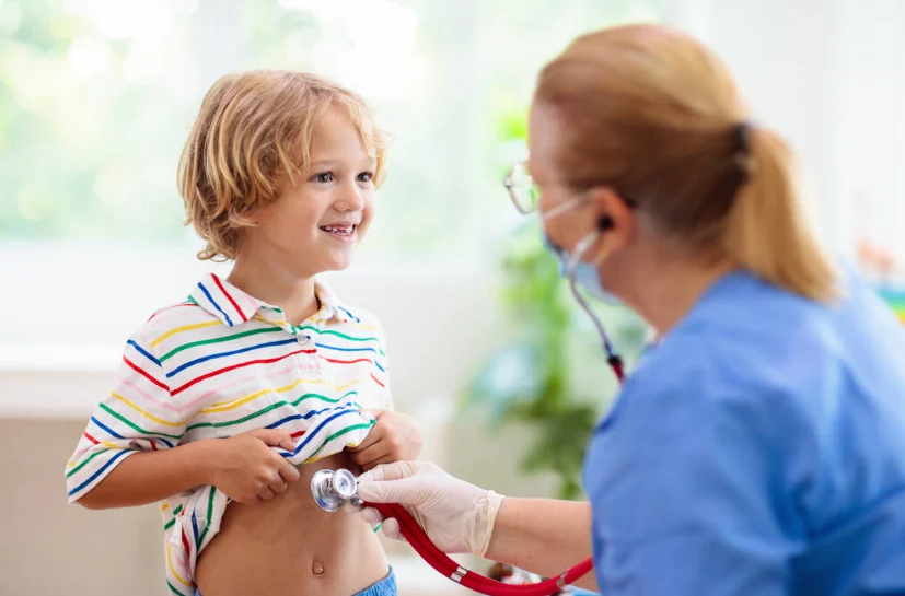Pediatric private duty nurse examining a child during a family nursing care visit